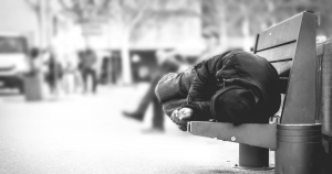 Homeless man on park bench
