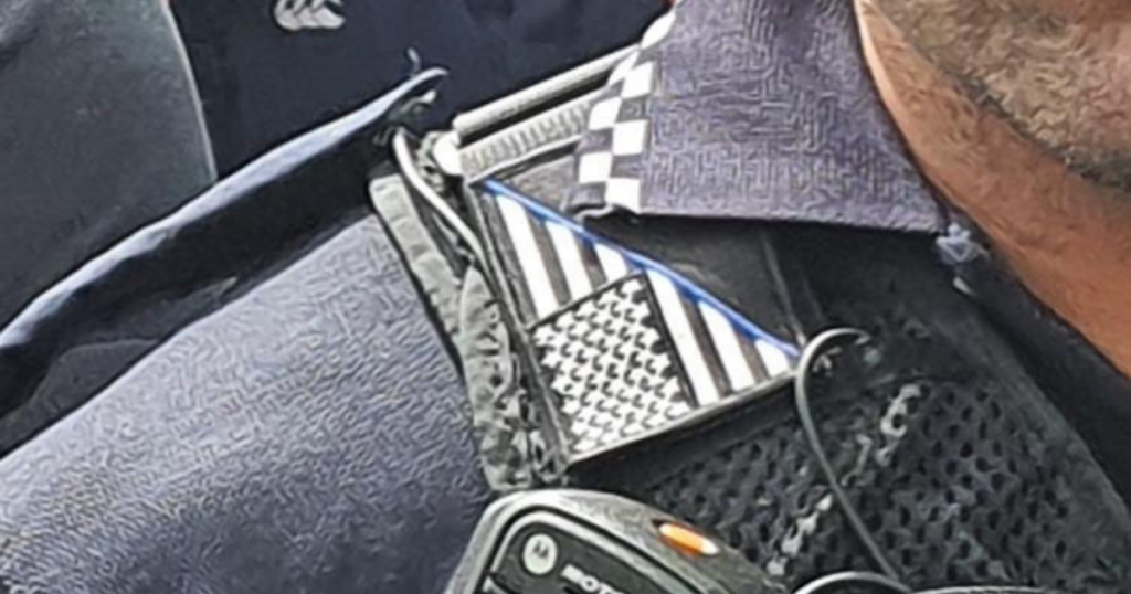 Queensland Police Officer with patch depicting a US flag bisected diagonally with a thin blue line