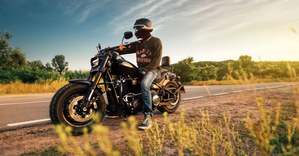 a man sitting on a motorbike roadside