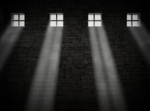 black and white image of 4 windows with light shining coming through