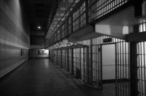 black and white photo of empty jail cells