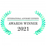 The image is a logo of the "International Advisory Experts Awards Winner 2021." It has green laurel branches on each side of the text.