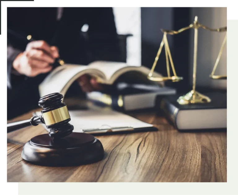 NSW Good Character Sentencing Bill 2026 | O'BRIEN CRIMINAL & CIVIL SOLICITORS A mans writing in a book with a gavel to his side and legal scales on the side sitting on a book