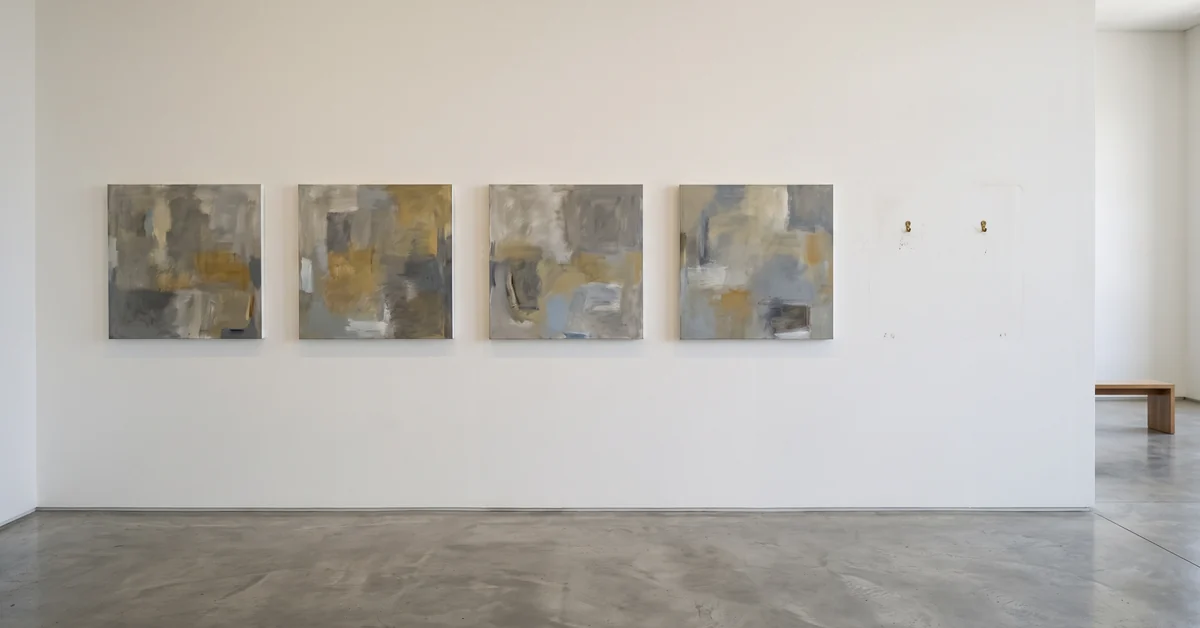 Gallery wall with four hung panels and one empty space where a fifth has been removed