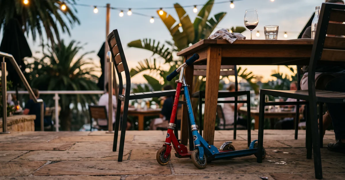 Two children's scooters leaning against a restaurant chair