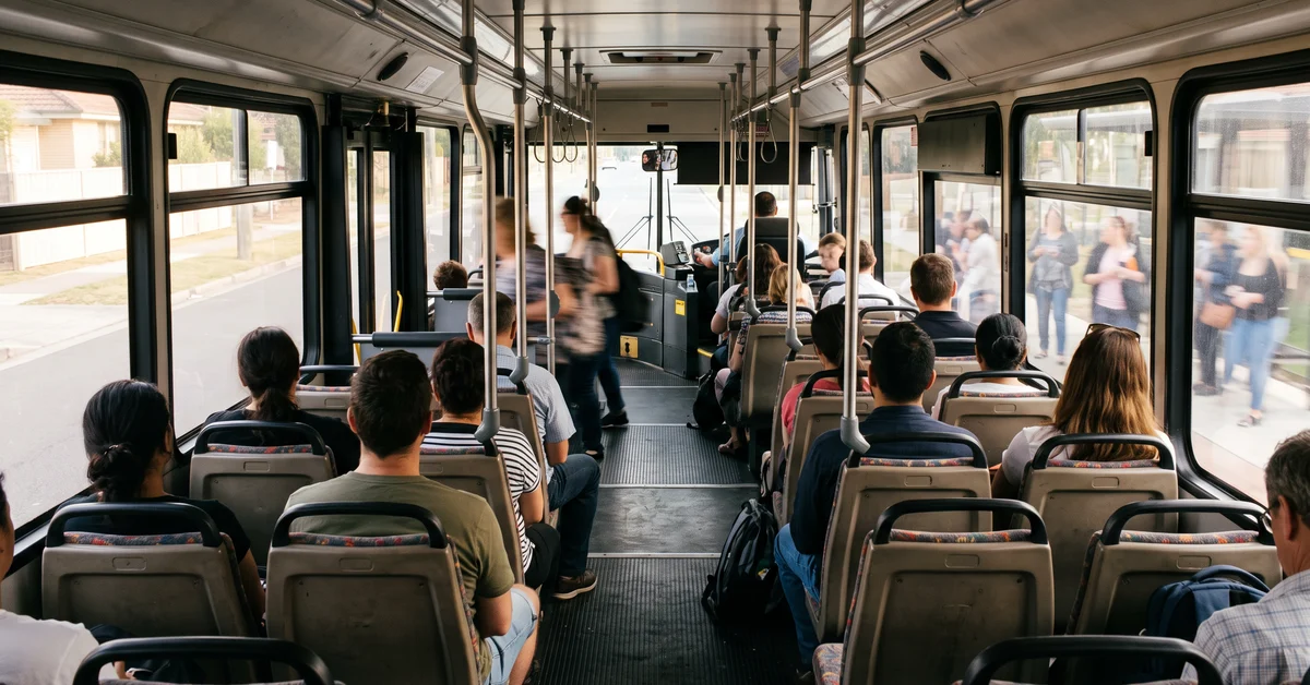 Empty bus interior with the front doors open at a kerb