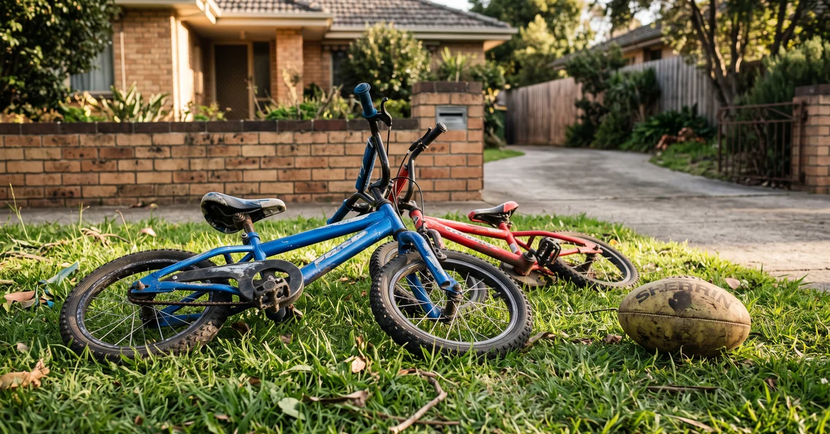 Children's bikes dropped on a suburban front lawn