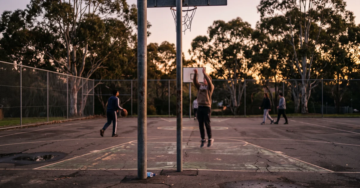 Empty suburban basketball half court at dusk