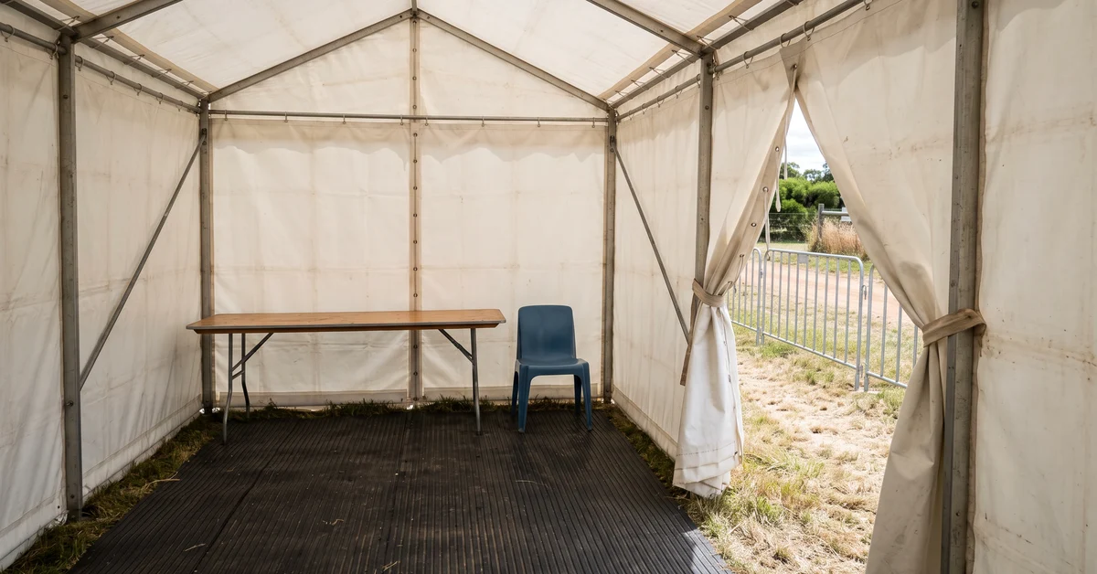 Empty white search marquee at a festival site