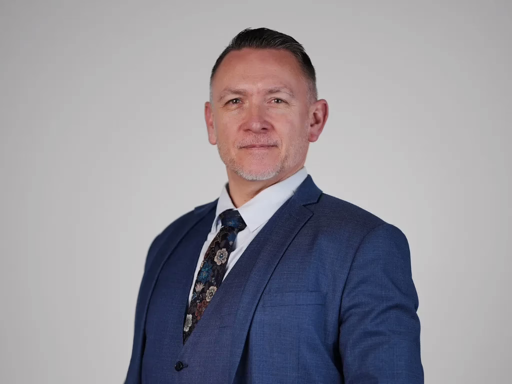 portrait of stewart o'connell wearing a suit and tie 
