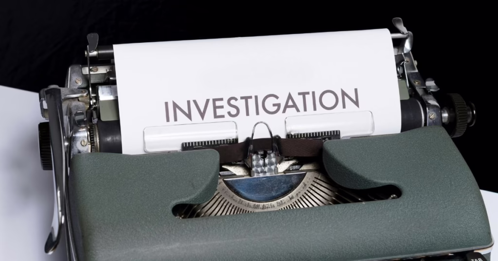 a typewriter with a page in it saying investigation