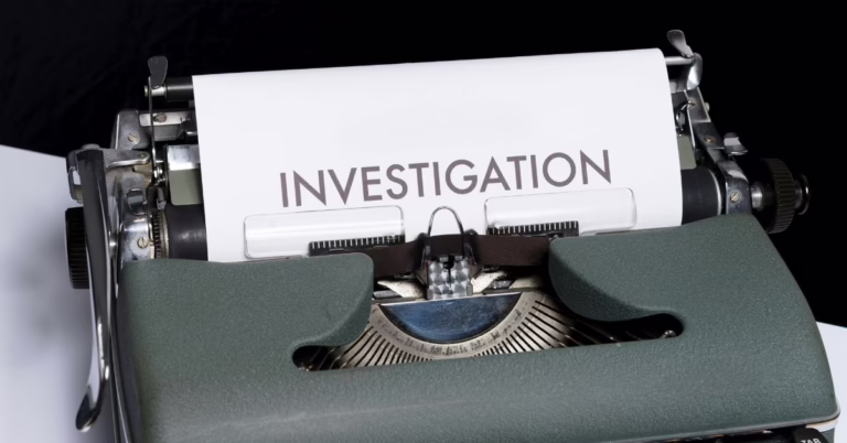 a typewriter with a page in it saying investigation