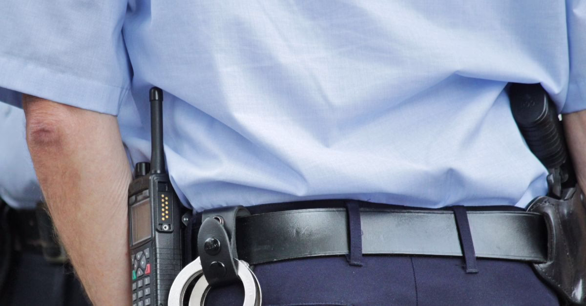 Unlawful Assault Suing NSW Police 2 | O'BRIEN CRIMINAL & CIVIL SOLICITORS A police officer's belt showing handcuffs and radio