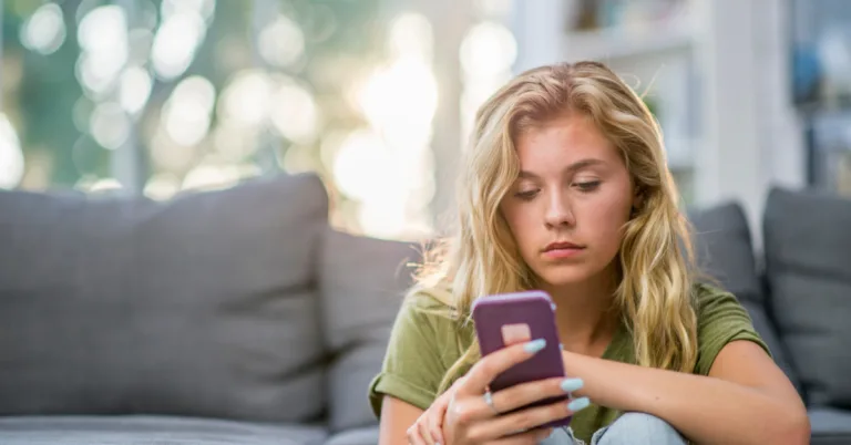 woman distressed looking at phone